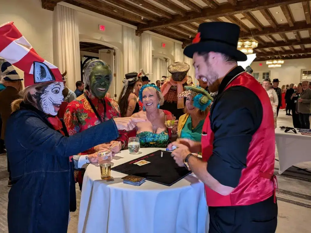 Magician performing close-up magic for party guests