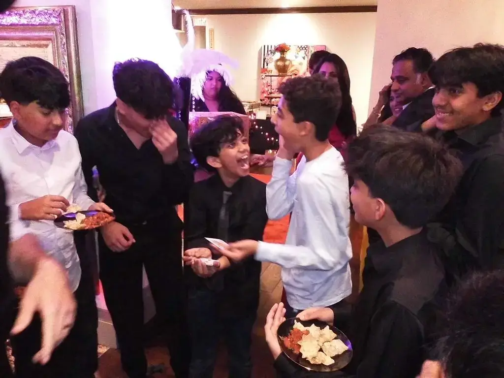 Party guests reacting to a magic trick